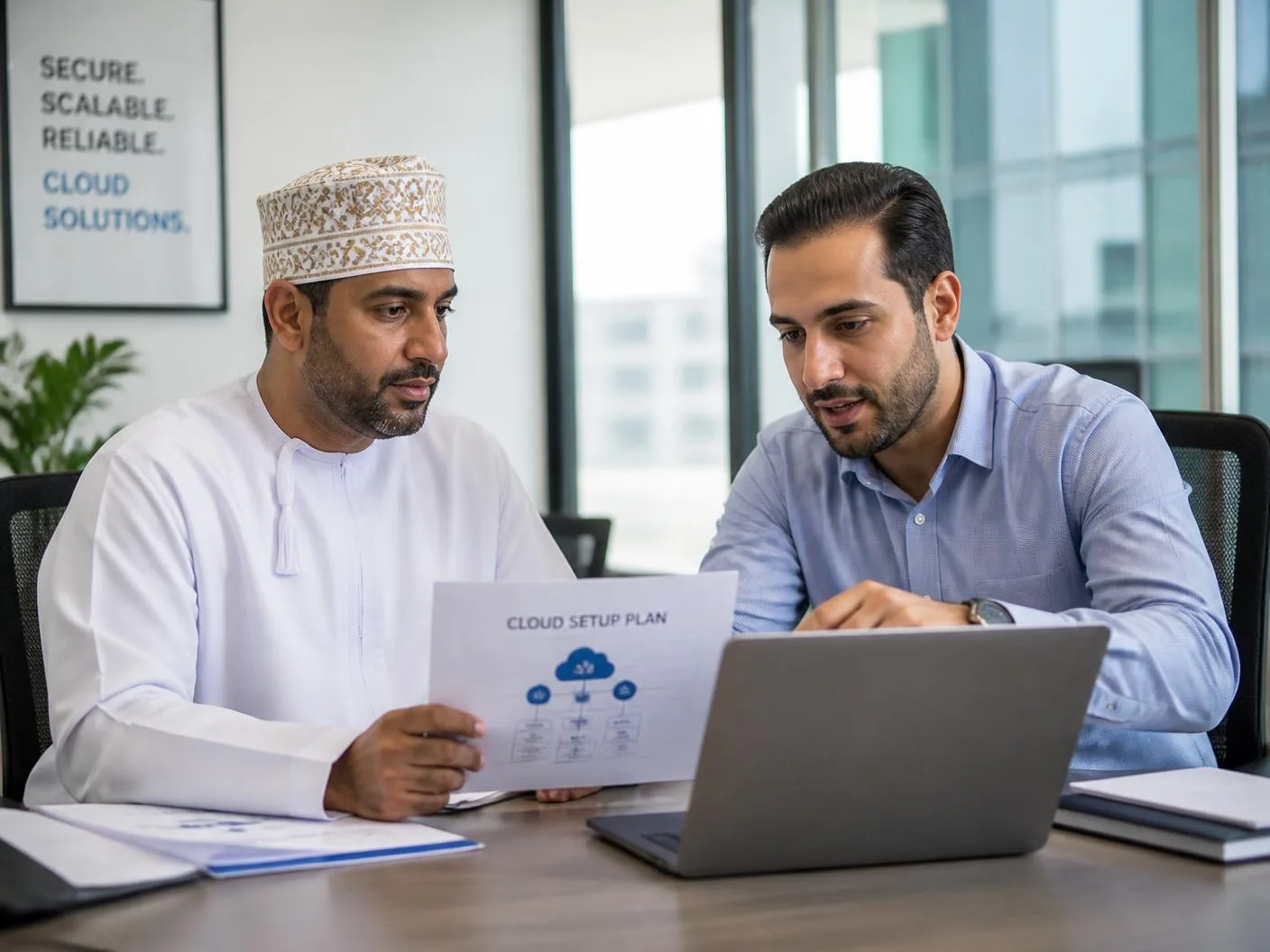 An Omani business owner and an Arab IT consultant reviewing a Microsoft 365 setup plan